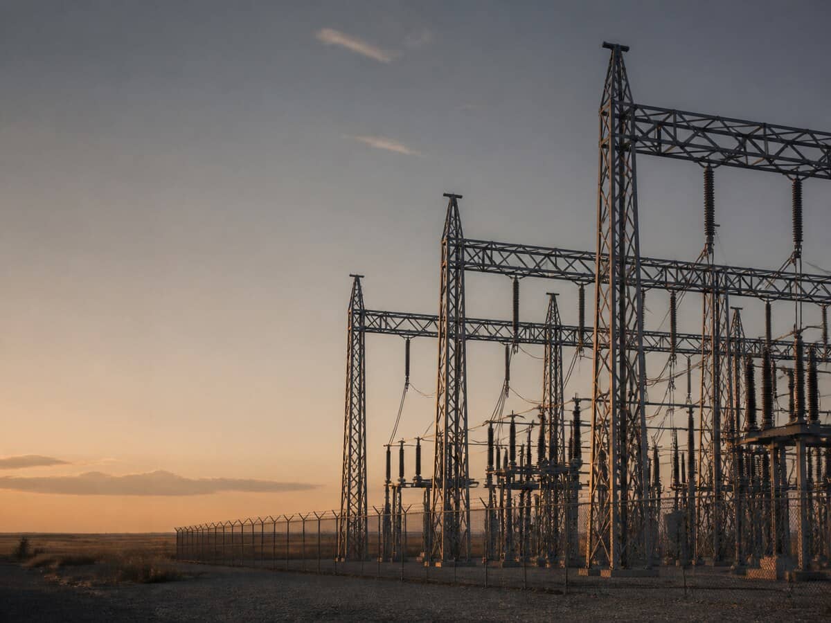 Steel lattice structures of an electrical substation against a dawn sky